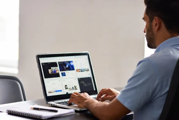 entrepreneur comparing ecommerce platforms on laptop