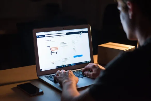 Customer making an online purchase late at night on a laptop